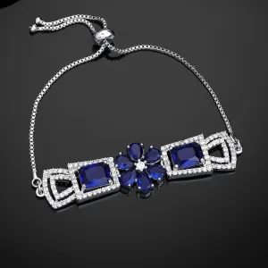 Estele Rhodium Plated Exquisite Floral Motif Enhanced Adjustable Charm Bracelet with Classic Blue American Diamonds for Women